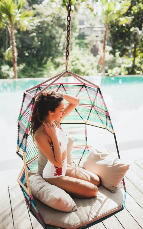 woman-in-white-swimsuit-enjoying-in-hanging-chair-swing-on-poolside-in-luxury-hotel-1-1-q2pr4l4pg2u7r0bwnvitt9qzshxc8yol8kksiliatc